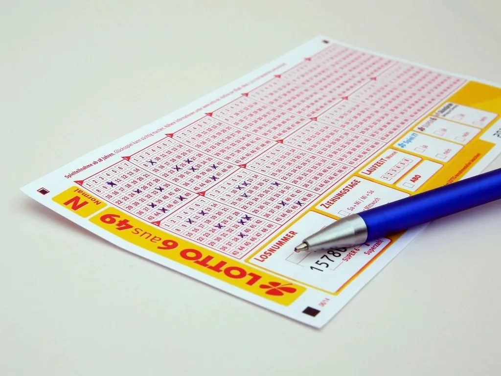 A lottery ticket and a pen