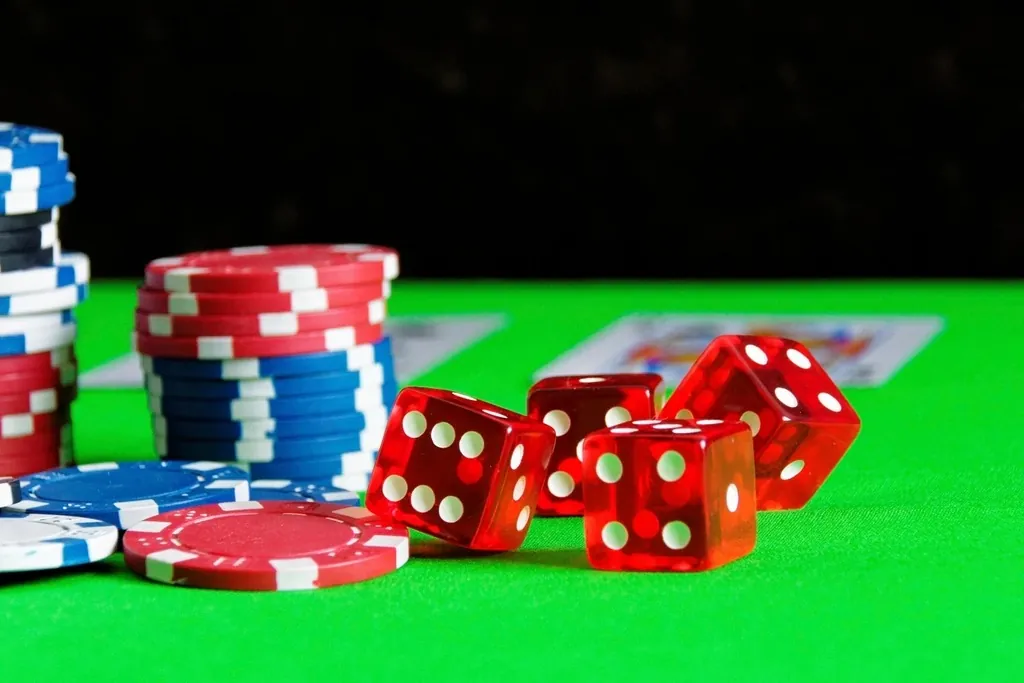 Poker chips stacked beside the cards