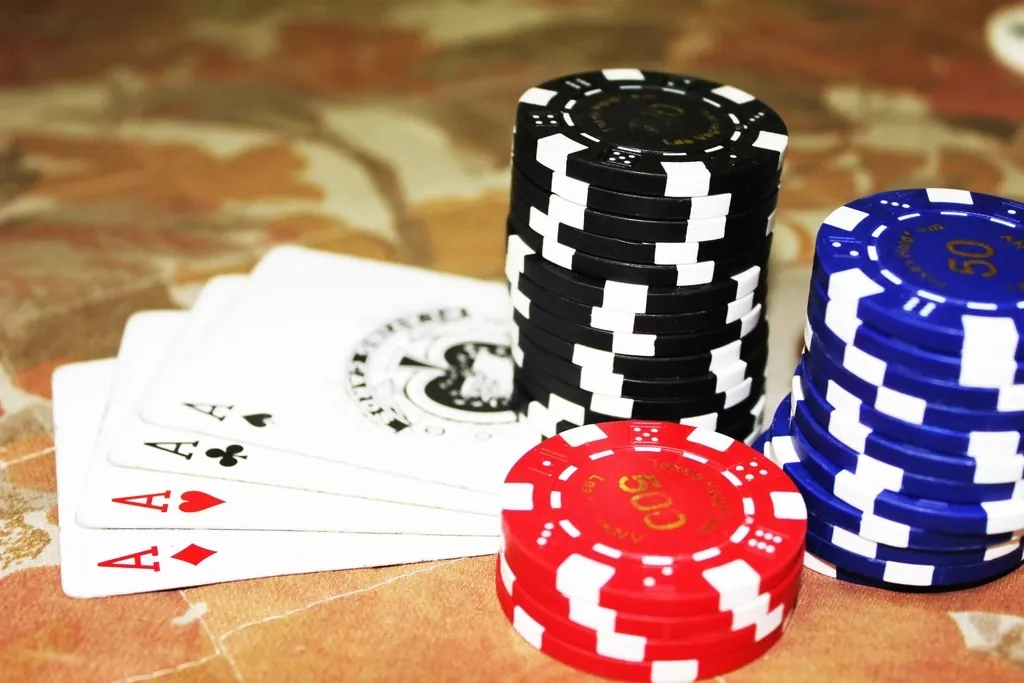 Poker chips stacked beside the cards