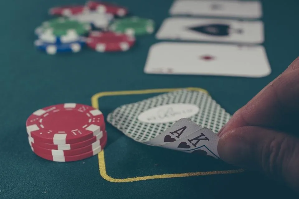 Poker chips stacked beside the cards