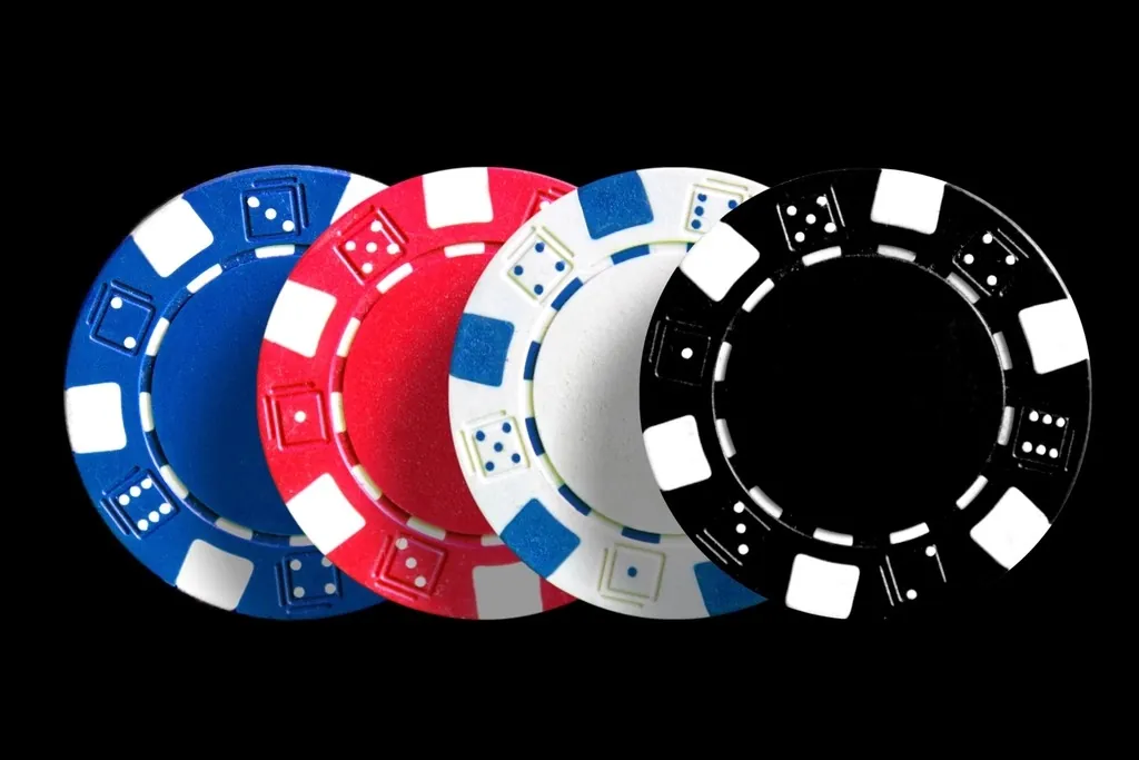 Poker chips stacked beside the cards