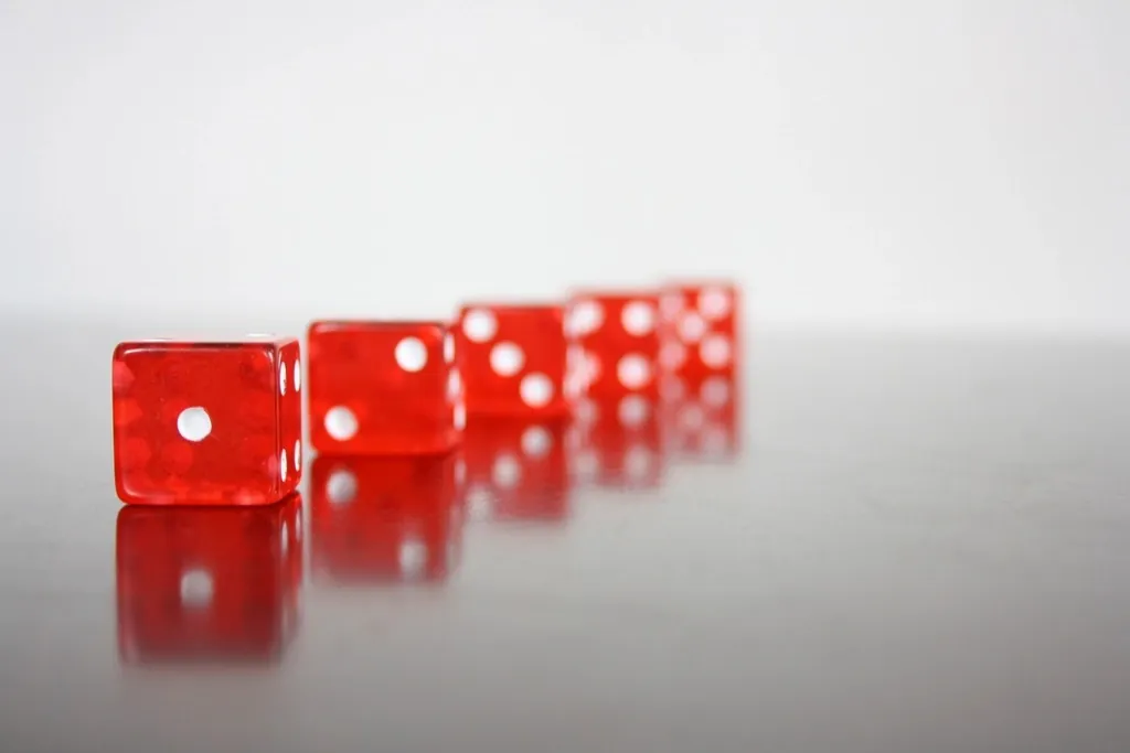 Poker chips stacked beside the cards